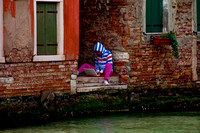 Young Girl Apple Computing Along a Venice Waterway