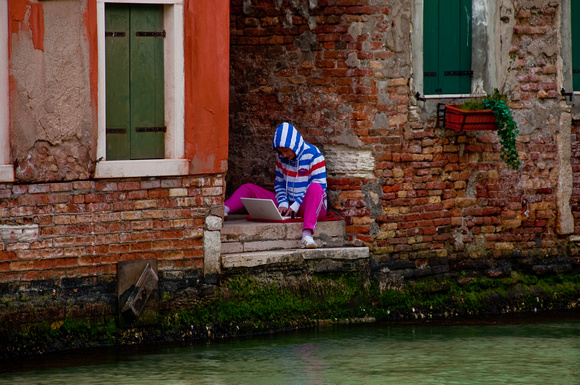 Young Girl Apple Computing Along a Venice Waterway